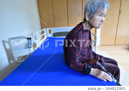 介護ベッドに座るシニア女性 介護ベッドに座るシニア女性 104822901