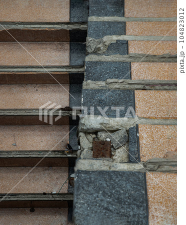 View of The old cement staircase is in the abandoned building and was left to deteriorate over years. View of The old cement staircase is in the abandoned building and was left to deteriorate over years. 104823012
