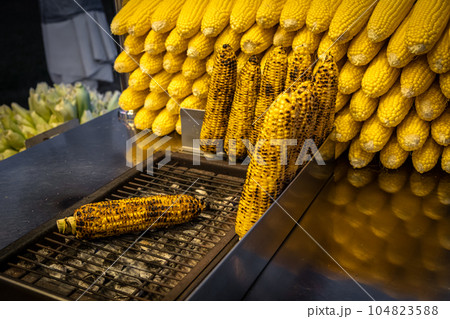 A street vendor roasts corn on a charcoal grill in Istanbul, Turkey. Misir, a popular Turkish street food, is freshly boiled or grilled sweet corn on the cob sprinkled with salt and spices. A street vendor roasts corn on a charcoal grill in Istanbul, Turkey. Misir, a popular Turkish street food, is freshly boiled or grilled sweet corn on the cob sprinkled with salt and spices. 104823588