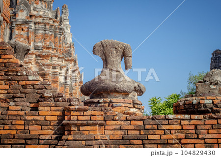 Broken ancient Buddha statue 104829430