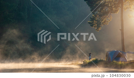 photographer takes pictures morning fog 104830030