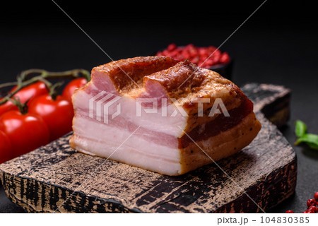 Delicious calorie smoked bacon with salt, spices and herbs 104830385