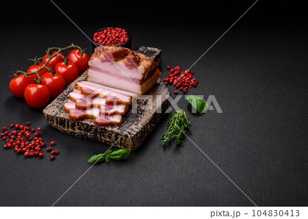Delicious calorie smoked bacon with salt, spices and herbs 104830413