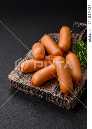 Delicious fresh boiled sausages with salt, spices and herbs 104830435