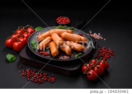Delicious fresh boiled sausages with salt, spices and herbs 104830461