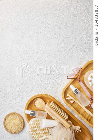 Spa and bathroom accessories on wooden tray, brush, oil, cream Spa and bathroom accessories on wooden tray, brush, oil, cream 104832837