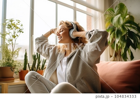 Cheerful woman listening to music and dancing. Generative AI Cheerful woman listening to music and dancing. Generative AI 104834333