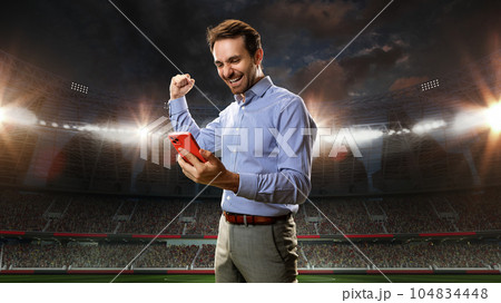 Positive, happy, emotional businessman holding mobile phone and celebrating money win. Sports betting. Luck. 3D arena background 104834448