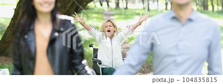 Happy couple forgot disabled woman in wheelchair outdoors. Happy couple forgot disabled woman in wheelchair outdoors. 104835815