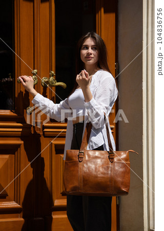 Street photo of young beautiful woman wearing stylish classic clothes. Female fashion concept. Street photo of young beautiful woman wearing stylish classic clothes. Female fashion concept. 104836756