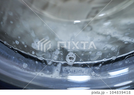 Wash white clothes. White towels in a closed washing machine. Disinfect the laundry. High quality photo 104839418