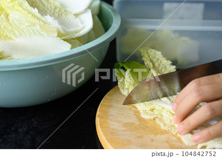 Chopped Chinese cabbage on cutting wooden board prepare for Korean kimchi cabbage Chopped Chinese cabbage on cutting wooden board prepare for Korean kimchi cabbage 104842752