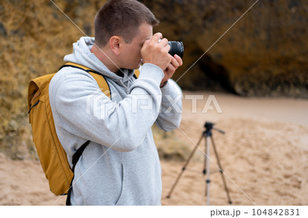 Traveler photographer takes photo beautiful seascape Traveler photographer takes photo beautiful seascape 104842831