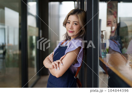Asian cafe owner or barista standing with smiling at cafe. woman small business owner in food and beverage Asian cafe owner or barista standing with smiling at cafe. woman small business owner in food and beverage 104844396