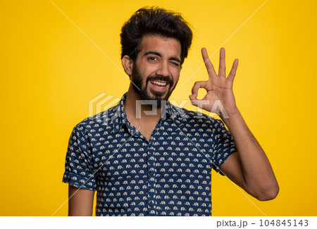 Man looking approvingly, showing ok approve feedback gesture like sign positive something good Man looking approvingly, showing ok approve feedback gesture like sign positive something good 104845143