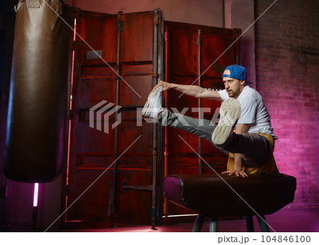 Bboy doing stunt on one hand, street artist breakdancing Bboy doing stunt on one hand, street artist breakdancing 104846100