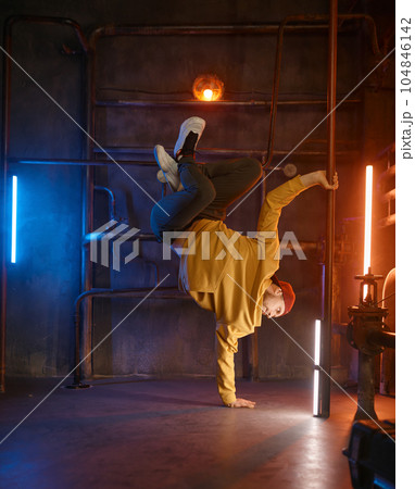 Modern hip hop dancer frozen in movie standing on one hand Modern hip hop dancer frozen in movie standing on one hand 104846142