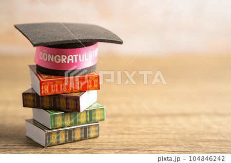 Graduation hat on book with copy space, learning university education concept. Graduation hat on book with copy space, learning university education concept. 104846242