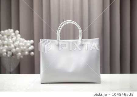 A mock-up of a white cloth bag is on the table A mock-up of a white cloth bag is on the table 104846538