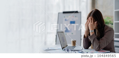 Portrait of sme business owner, woman using computer and financial statements Anxious expression on expanding the market to increase the ability to invest in business. Portrait of sme business owner, woman using computer and financial statements Anxious expression on expanding the market to increase the ability to invest in business. 104849565