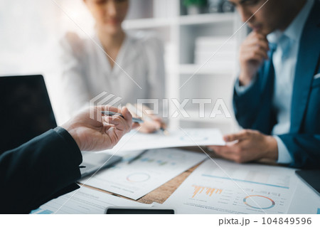 Asian business advisor meeting to analyze and discuss the situation on the financial report in the meeting room.Investment Consultant, Financial , teamwork ,brainstorming ,startup and accounting. 104849596