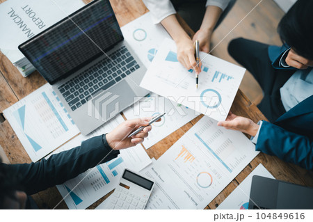 Asian business advisor meeting to analyze and discuss the situation on the financial report in the meeting room.Investment Consultant, Financial , teamwork ,brainstorming ,startup and accounting. 104849616