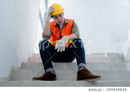 Engineers or architects show signs of exhaustion and discouragement from working on building structures Engineers or architects show signs of exhaustion and discouragement from working on building structures 104849648