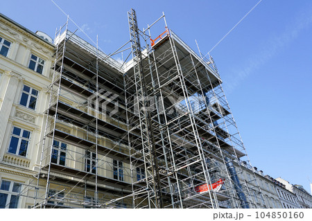 Restoration of the facade of a historic house using scaffolding with temporary elevator Restoration of the facade of a historic house using scaffolding with temporary elevator 104850160