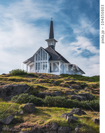 Modern exterior design of Icelandic church at the top of the rocky mountain with blue sky at the background Modern exterior design of Icelandic church at the top of the rocky mountain with blue sky at the background 104850803