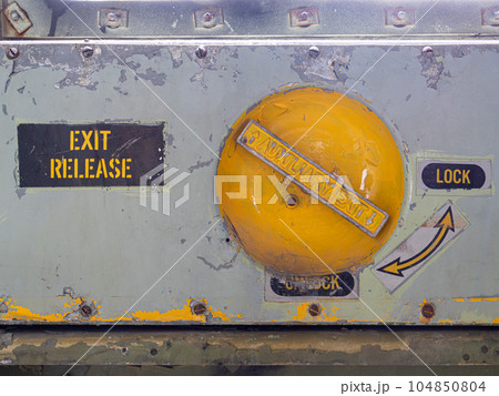 Old and rusty emergency exit release lock airplane mechanism Old and rusty emergency exit release lock airplane mechanism 104850804