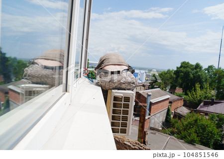 without a face. A man installs an external air conditioner. dangerous work. without a face. A man installs an external air conditioner. dangerous work. 104851546