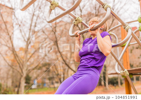 Calisthenics pull- up back exercise for cross fitness workout. Hispanic mid sportswoman athletic 104851991
