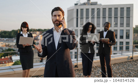 Business investors using modern technologies on office roof Business investors using modern technologies on office roof 104854526