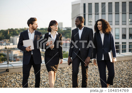 Diverse business partners walking after work conference 104854769