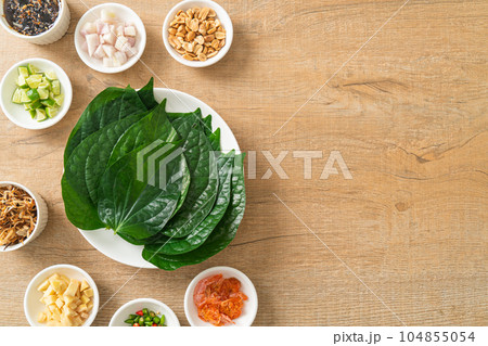 Miang kham - A royal leaf wrap appetizer Miang kham - A royal leaf wrap appetizer 104855054