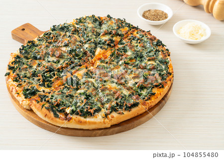 spinach and cheese pizza on wood tray spinach and cheese pizza on wood tray 104855480