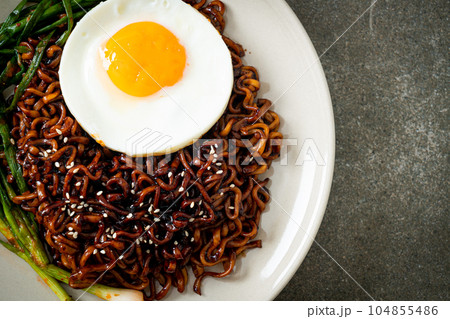 dried Korean spicy black sauce instant noodles with fried egg and kimchi dried Korean spicy black sauce instant noodles with fried egg and kimchi 104855486