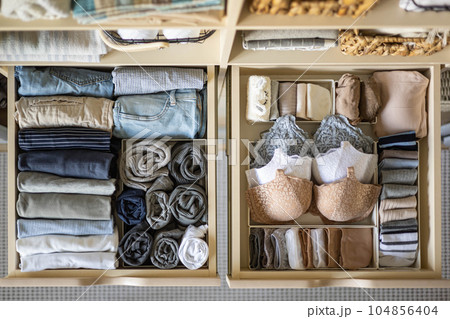Stylish and organized women's wardrobe. Beautiful clothes. Underwear, T-shirts and socks in a drawer. The concept of order and storage. Stylish and organized women's wardrobe. Beautiful clothes. Underwear, T-shirts and socks in a drawer. The concept of order and storage. 104856404