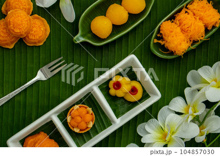 Thai traditional dessert concept, Assorted Thai dessert served in a plate on banana leaf background Thai traditional dessert concept, Assorted Thai dessert served in a plate on banana leaf background 104857030