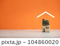 isolated ceramic home model covered by roof icon on orange background 104860020