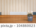 blooming cactus pot on wooden table 104860023