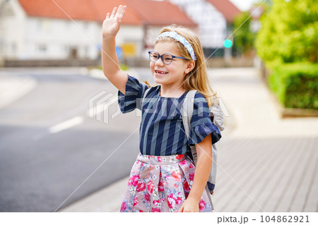 Little Preschool Girl on the Way to School. Healthy Happy Child Walking to Nursery School and Kindergarten. Smiling Child with Eyeglasses and Backpack on the City Street, Outdoors. Back to School. 104862921