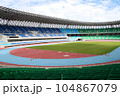 Rows of empty football stadium with green seats and blue sky in backgrounds for banners, posters, information graphics, prints layout covering books, magazine page, advertising material, advertisement 104867079