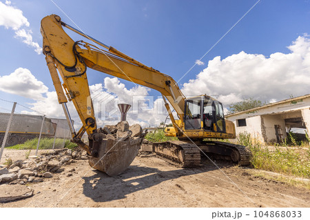 Crawler excavator on demolition site. Crawler excavator on demolition site. 104868033