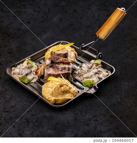Roasted pork medallions with grilled duck liver 104868057