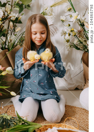 Two girls in a beautiful Easter photo zone with flowers, eggs, chickens and Easter bunnies. Happy Easter holiday. Two girls in a beautiful Easter photo zone with flowers, eggs, chickens and Easter bunnies. Happy Easter holiday. 104868798