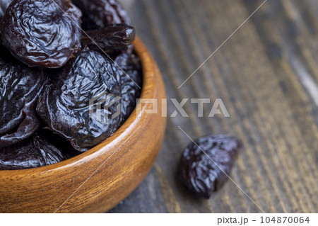 Dried plums on the kitchen table 104870064