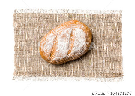 Freshly baked delicious french bread with napkin isolated on white background top view. Healthy white bread loaf Freshly baked delicious french bread with napkin isolated on white background top view. Healthy white bread loaf 104871276