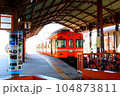 レトロな駅のホームに停車する赤い電車 104873811