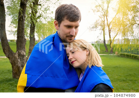 Happy people together with ukraine flag in the park. Free lifestyle Happy people together with ukraine flag in the park. Free lifestyle 104874980